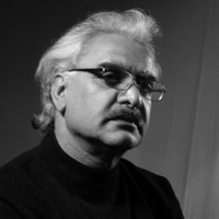 Prof. Zargar Zahoor, contemporary artist, in his studio surrounded by his minimalist paintings